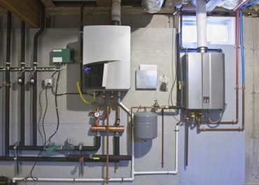 COMM_PLUM-_0004_tankless-hot-water-system-in-the-basement-of-a-green-technology-home-529577258-77afda16fd494c6899a780008
